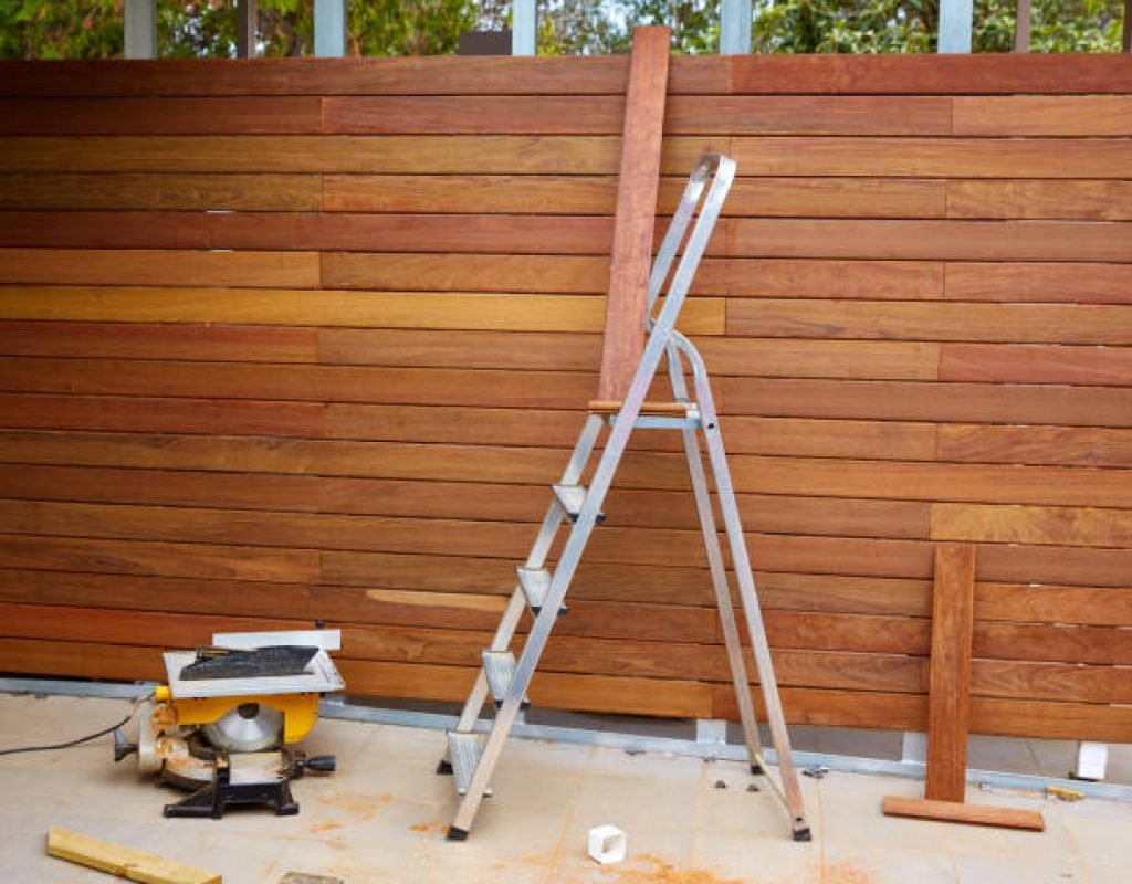 Ornamental metal fence enclosing a front yard with landscaping accents
